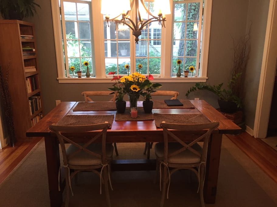 The dining room features a handcrafted table and plenty of space to enjoy your meals.