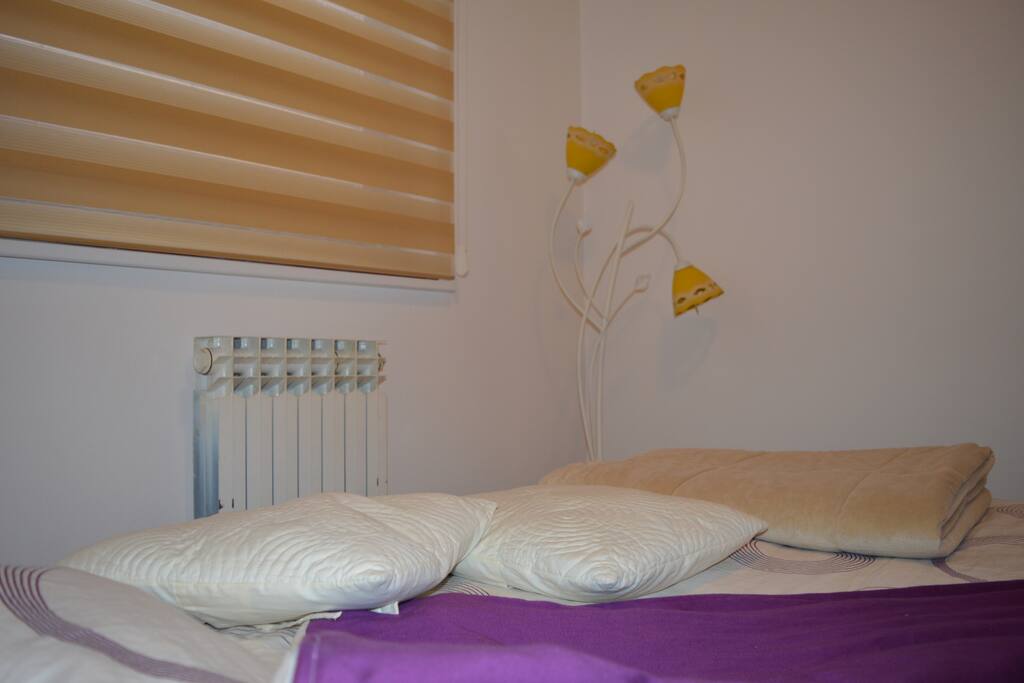 Room with double bed, TV and heating