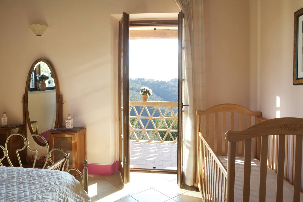 romantic double bedroom with direct access to the private terrace with glorious view on the valleys and the hills