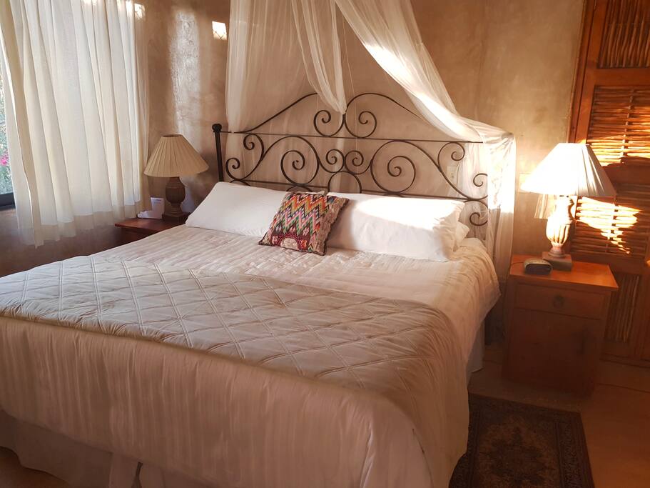 King size bed with cotton sheets and down comforter
