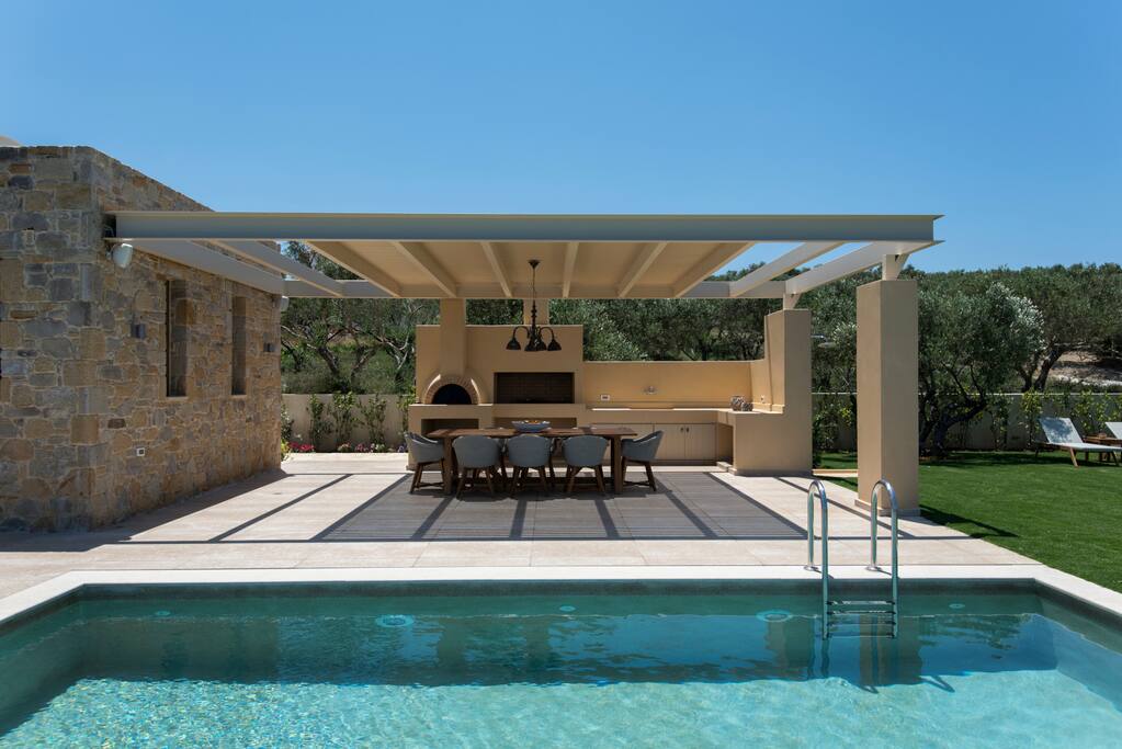 Outdoor barbeque area with a dinning table suitable for 8 people