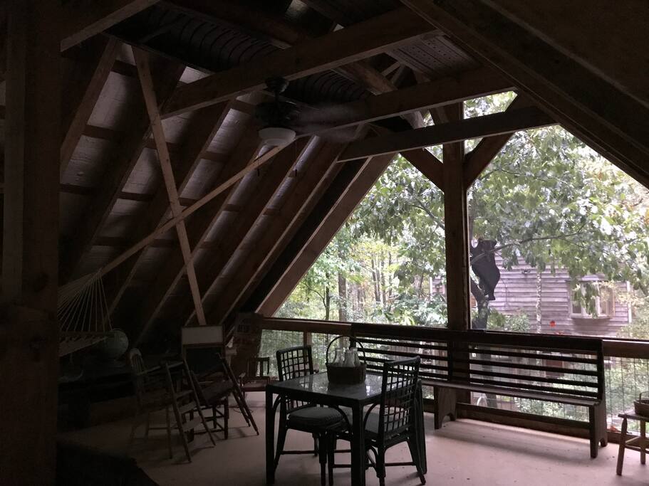 Interior view, (if you can zoom in our house is in background-30 yds away which ensures your privacy). Sleeping Porch space is 28 x 28 w/sleeping loft, hammock, sitting areas, dining area and outdoor deck overlooking the creek.