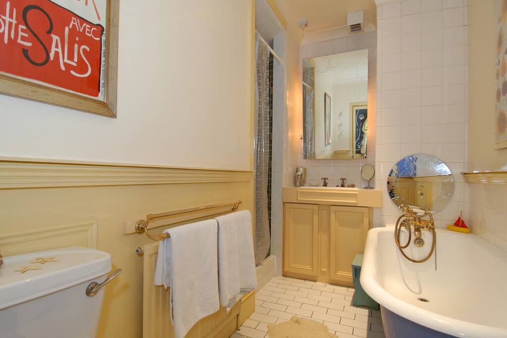 bathroom with double shower and roll top bath