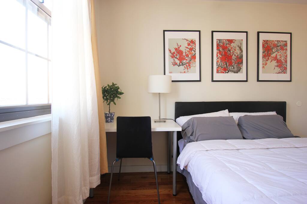 Large, sunny bedroom with peaceful floral accents