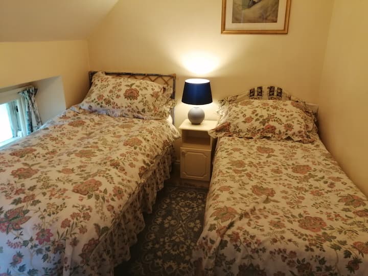 This is another view of the small bedroom made up as a twin room.  The bed on the right has the folding legs and is a small single, so best suited to a younger / smaller person. 