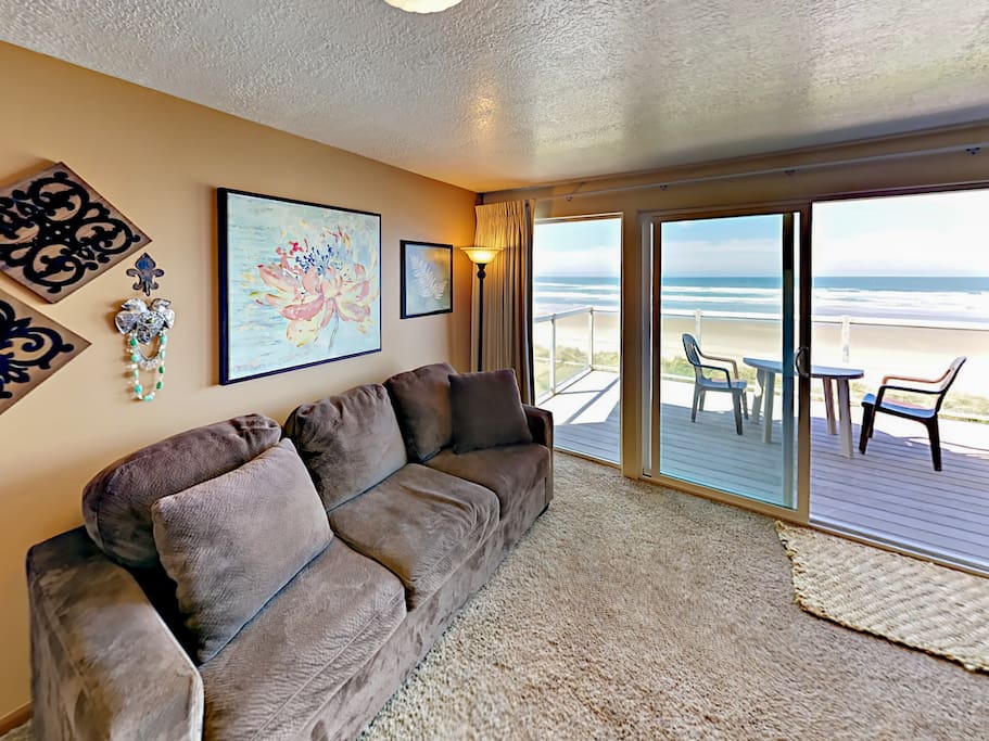 Sliding glass doors open to the spacious balcony with a 2-person table.