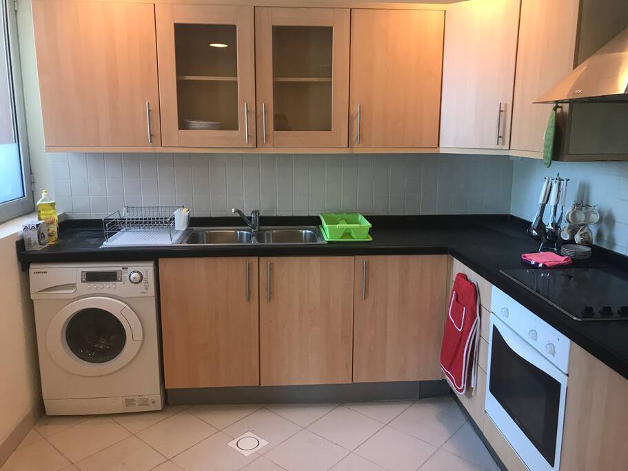 An open kitchen with essentials, microwave and oven.