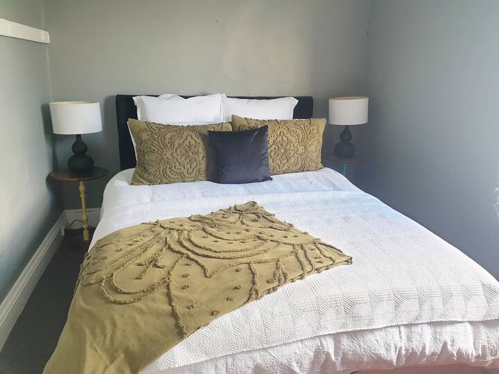 Queen Room with queen sized bed and Australian Cedar wardrobe. This room has great district views to the mountain ranges. Enjoy the sunrise from your pillow
