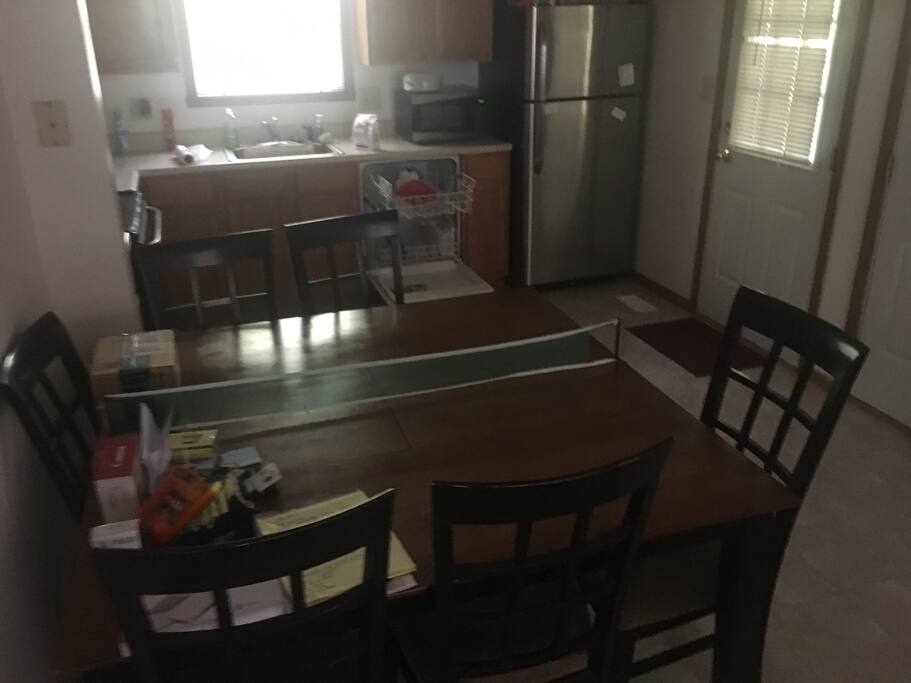 Full kitchen and dining area / table.