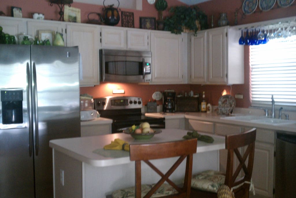 Kitchen Area With Window View to Pool & Garden