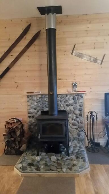 Wood stove. The rock surround was made with stones from the riverbed.