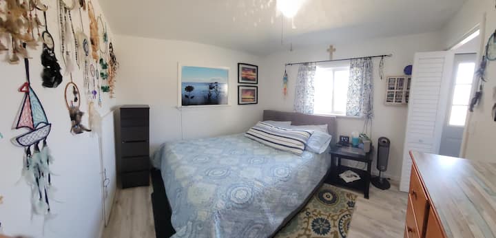 Bedroom with queen bed and view of lake