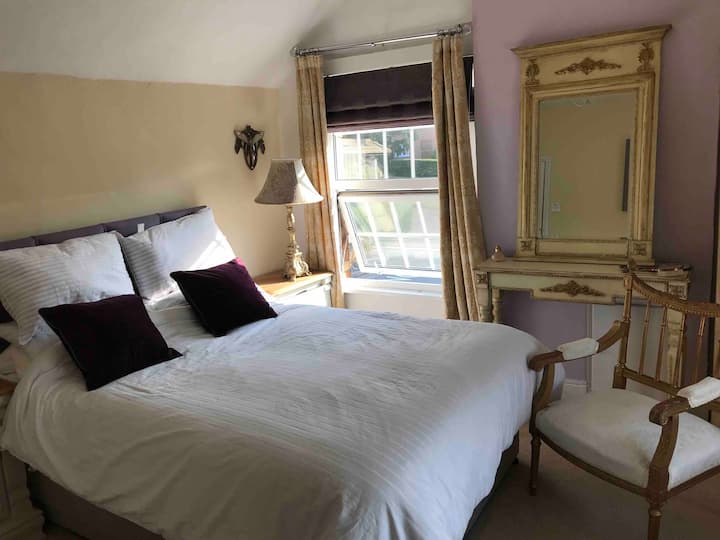 A  very spacious double aspect bedroom with antique furniture, stocked minibar and welcome basket including homemade cake. Complimentary tea/coffee/bottled water. TV, WiFi, hairdryer and iron. Double wardrobe with a dressing table and cheval mirror.