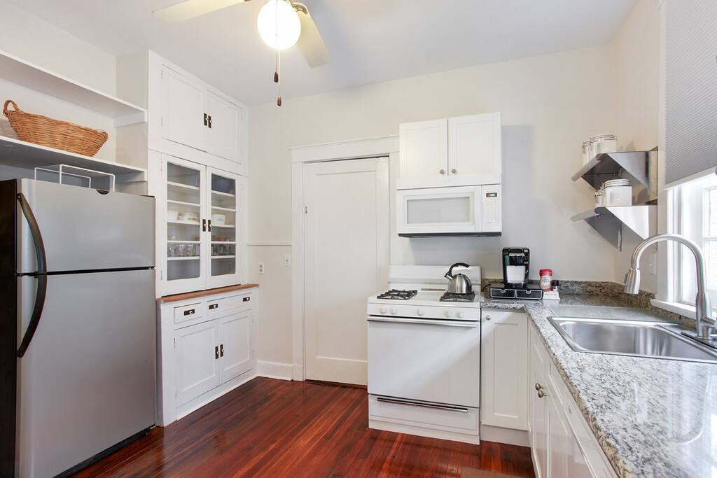 Kitchen is stocked with cooking basics - pots, pans and utensils.