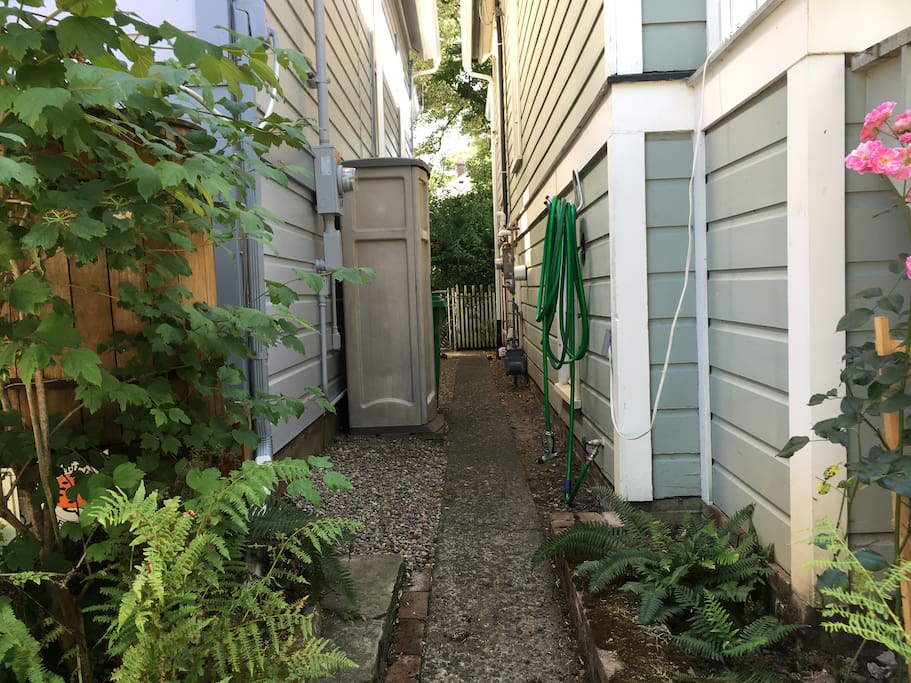 Walk between the houses to the back