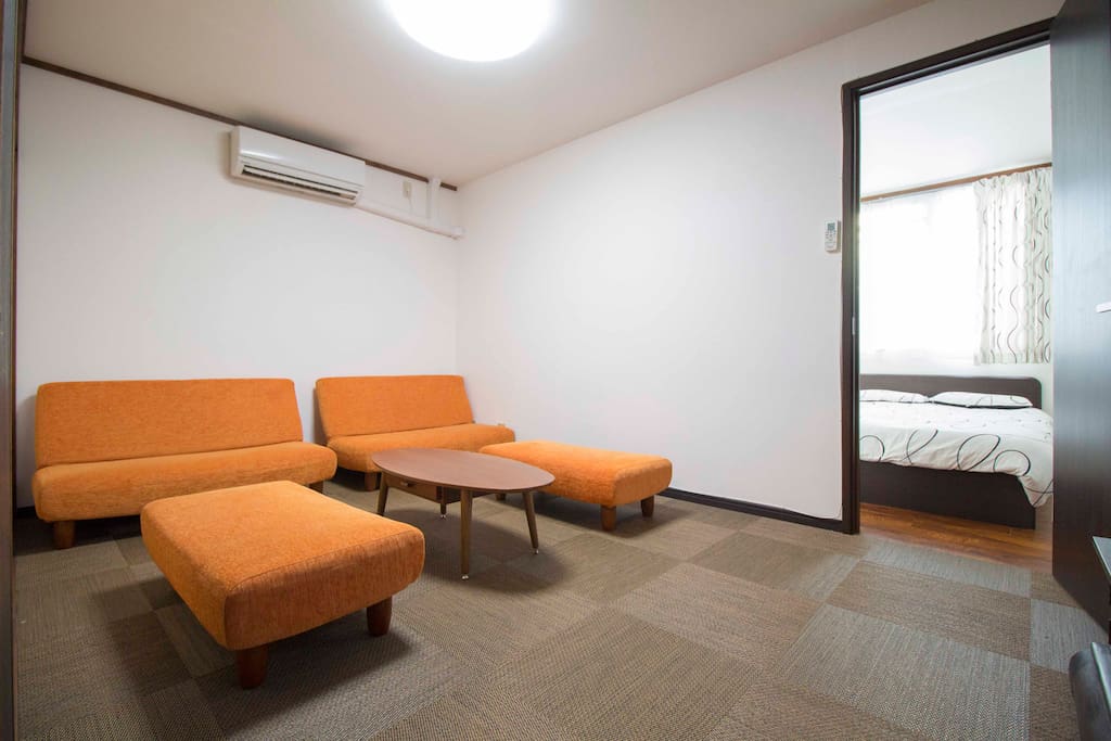 Lounge area with couches and a big, flat-screen TV. Perfect for enjoying the crazy television shows Japan has to offer.