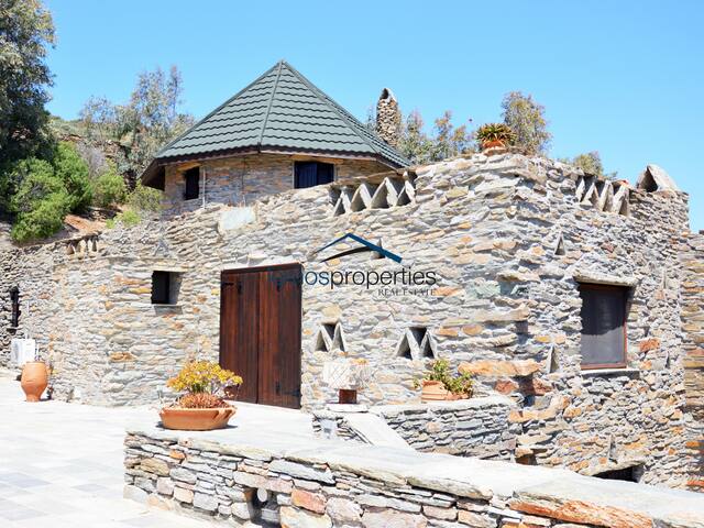 Traditional stone built windmill with a sea view