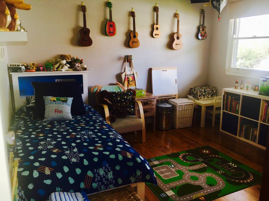 Childs room with single bed, toys and lots of books.