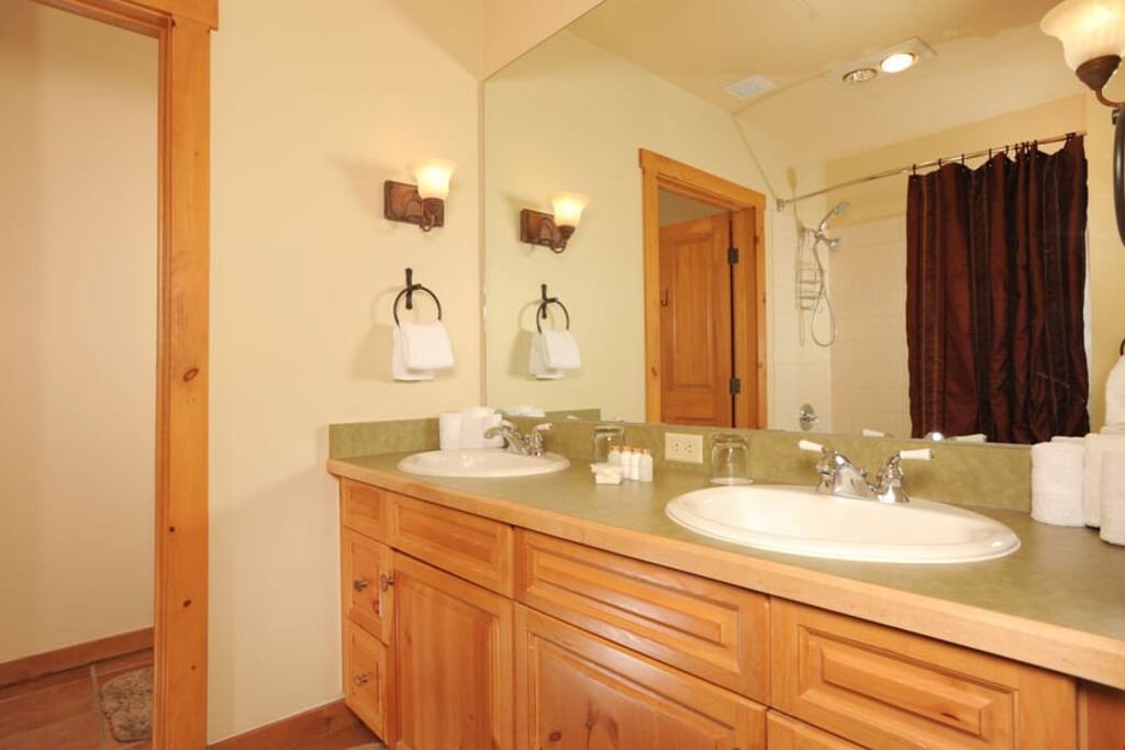 The bathroom includes a shower, tub and double vanity
