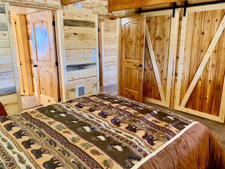 There is one bedroom downstairs with a queen sized log bed. 