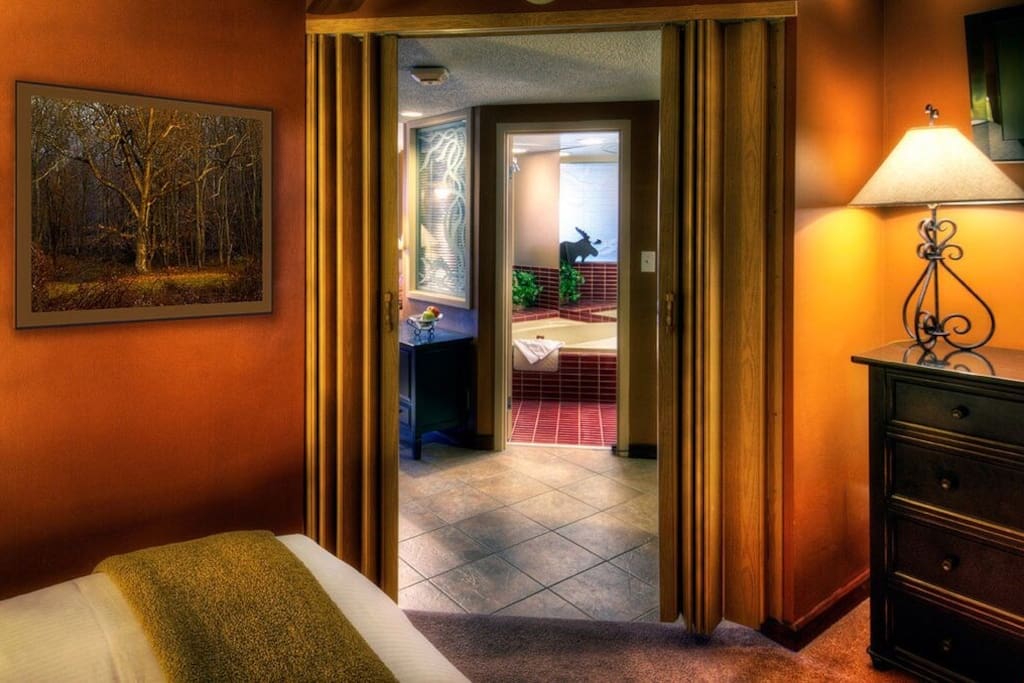 The queen sized bed can be found in the separated bedroom area.