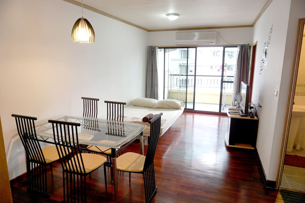 The main living room with dining table and sofa bed