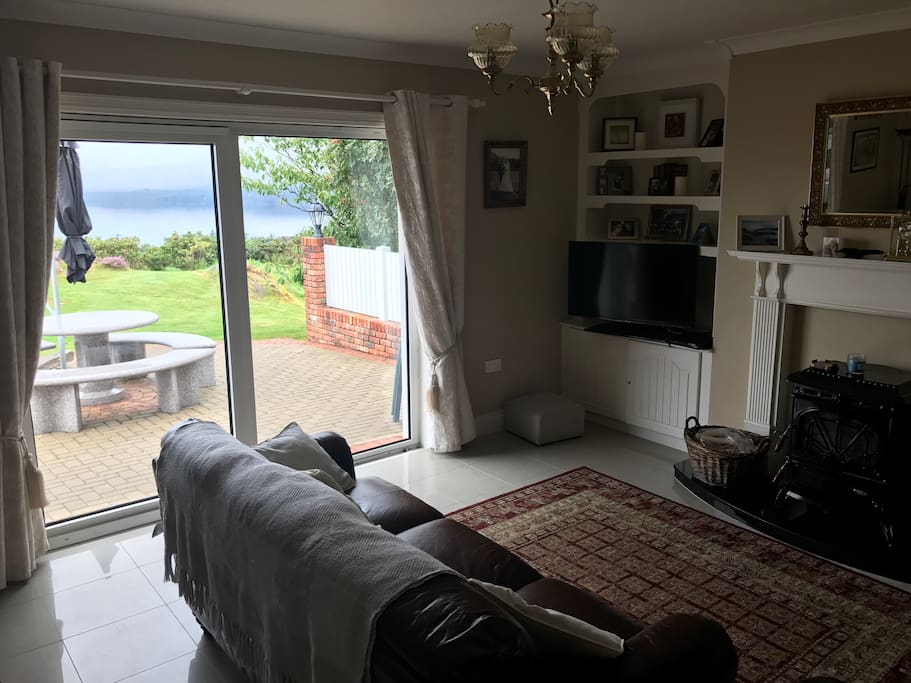 Comfortable living room with log burning stove and an unrivalled view over the Atlantic