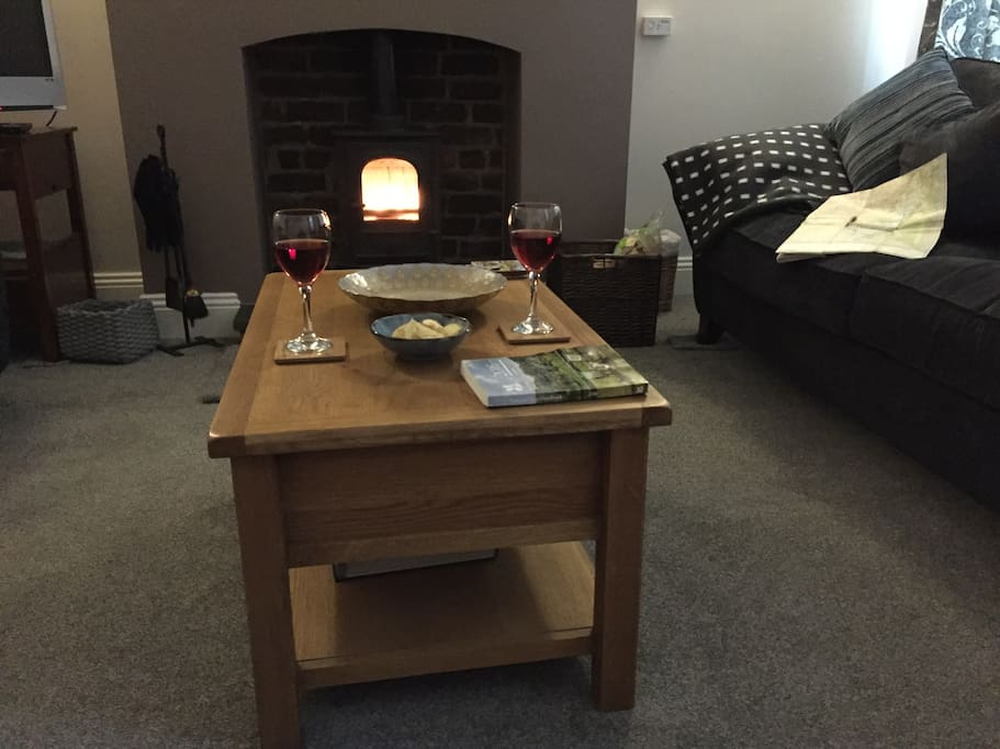 light airy spacious lounge with big comfy sofas, a Stovax wood burner on a green slate hearth