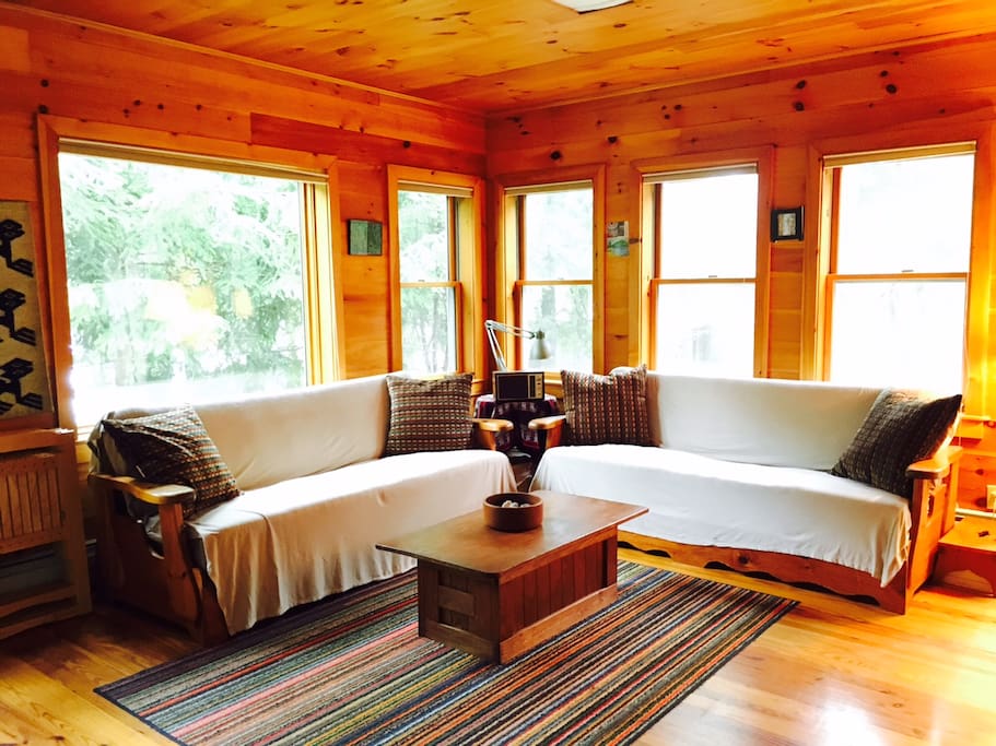 A cozy living room across from the kitchen to relax after a long day of exploring acadia