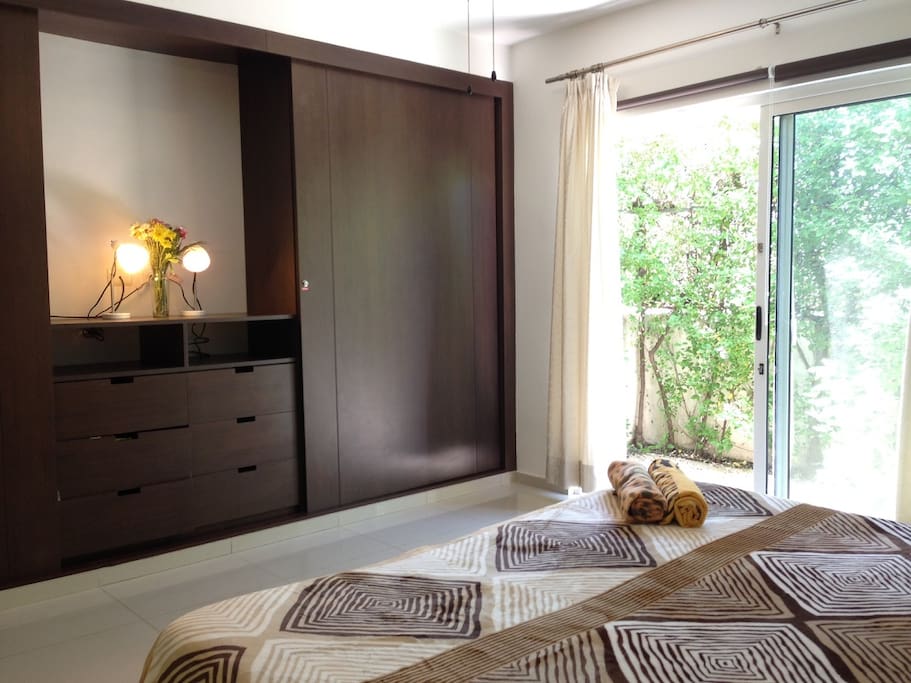 The bedroom has a big size closets and has a little patio