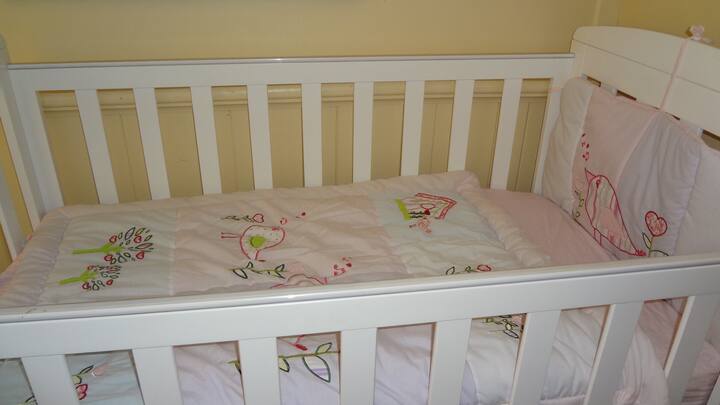 Cot, suitable for younger babies, and highchair available on request. 