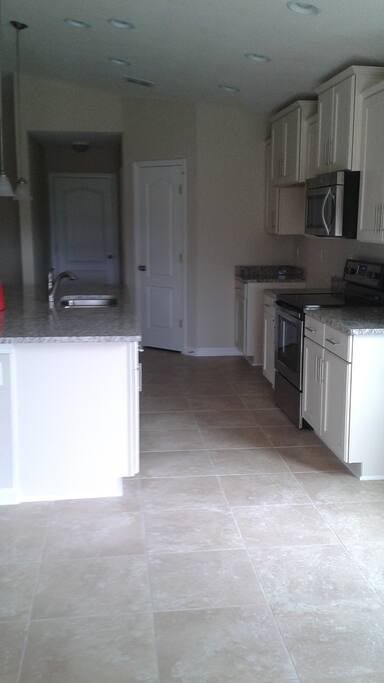 Kitchen area all modern appliances, dishwasher, fridge, and stove