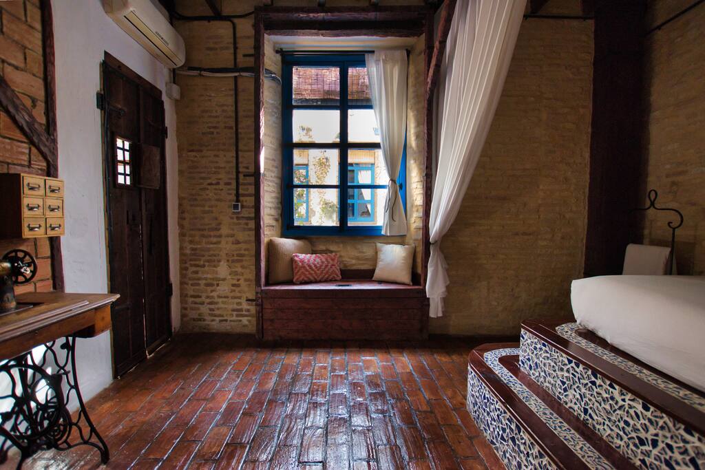 Sit on top of the hand made chest and look out the old style window to the downstairs courtyard.