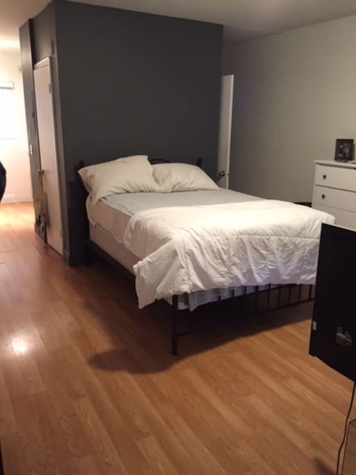Living space with Full size bet.