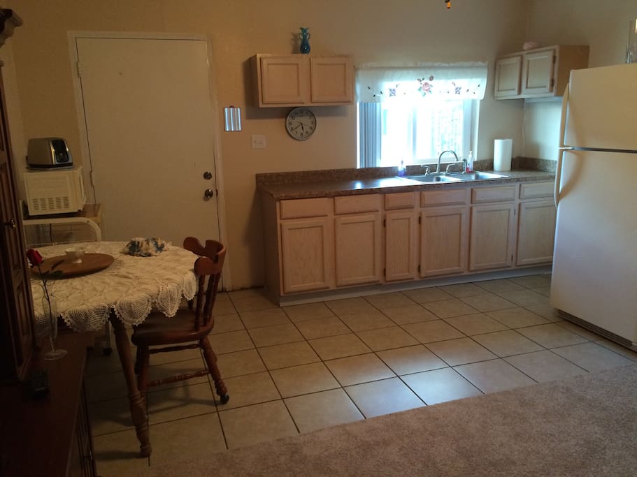 Kitchenette with dishes and full refrigerator
