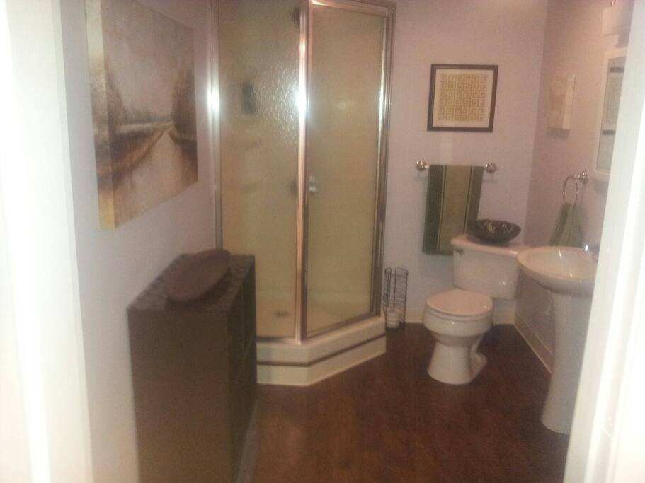 Private bathroom with linen closet and storage closet.