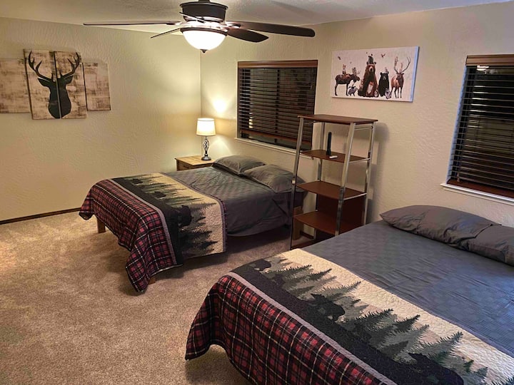 Upstairs bedroom with 2 queen beds, huge closet (with [porta-crib and dog beds available for you to use), attached bathroom and 55" Firestick TV.