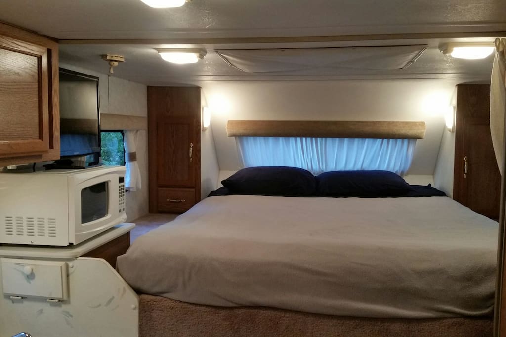 Queen sized bed with lots of storage and LED TV with Blu-Ray player.