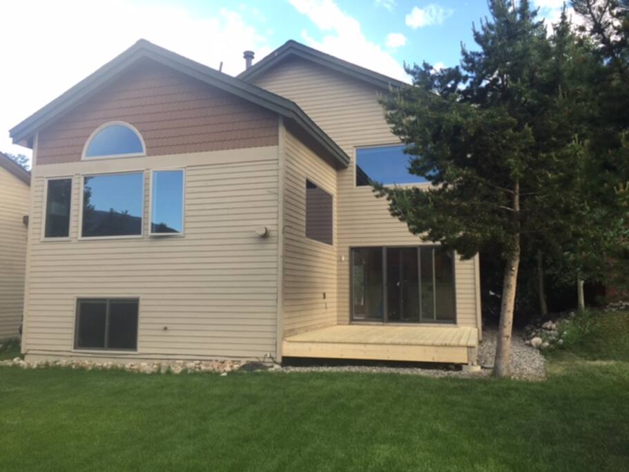View of house from beautifully maintained back yard and willows/wildlife