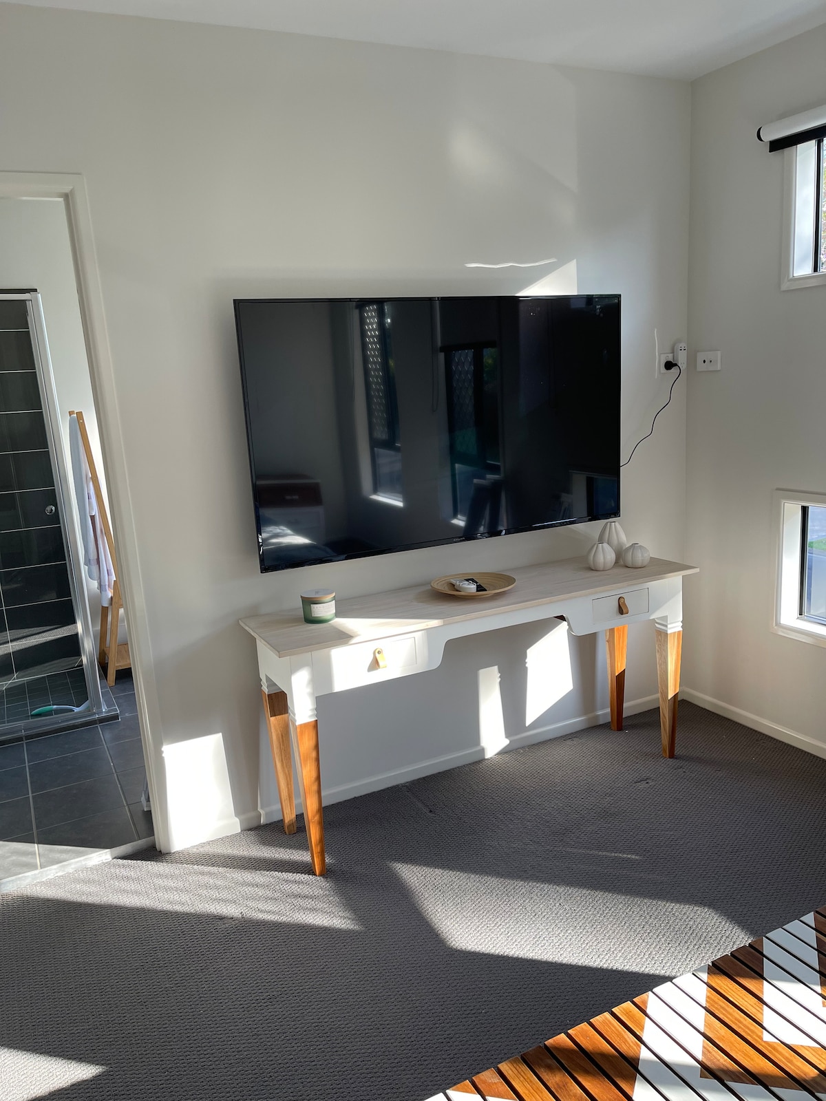 The sunlit view from the main bed (and in case you missed it- a huge 75” TV 