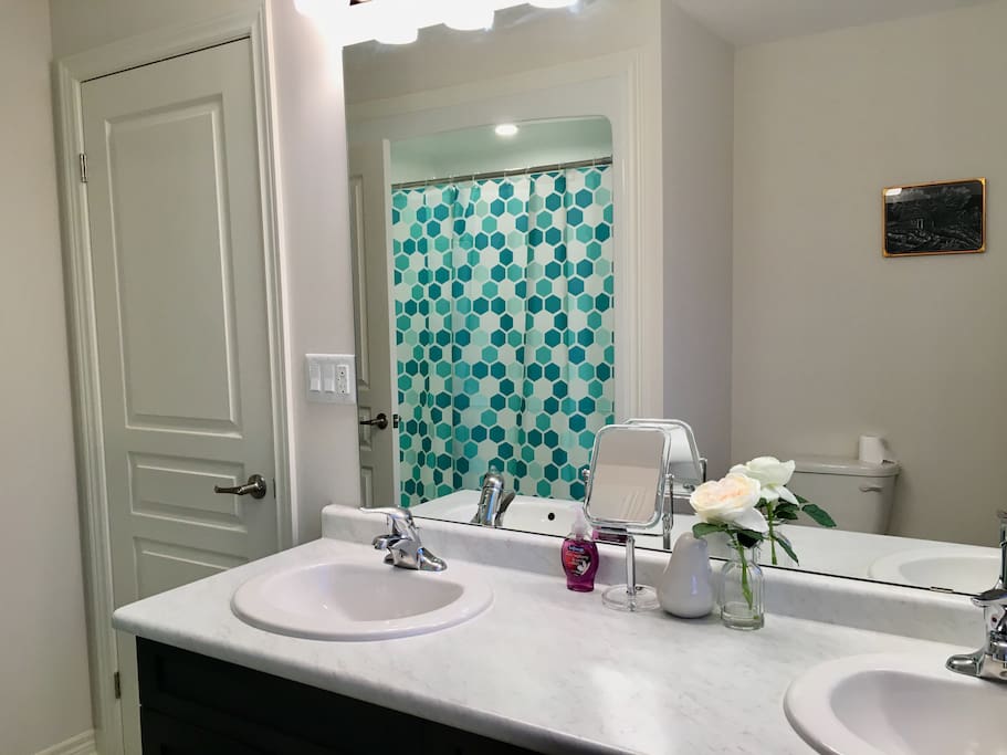spacious attached washroom with double sink