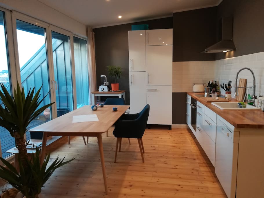 Living room with sunny kitchen and balcony attached
