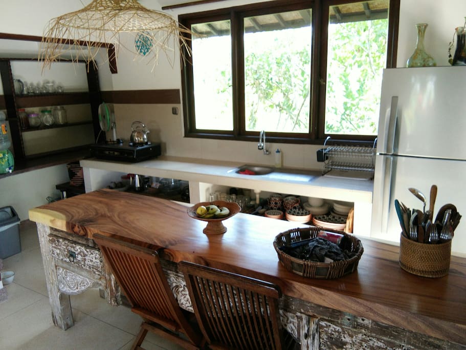 A fully equipped kitchen with a beautiful teak wooden counter top, window aspect faces the rice fields and garden