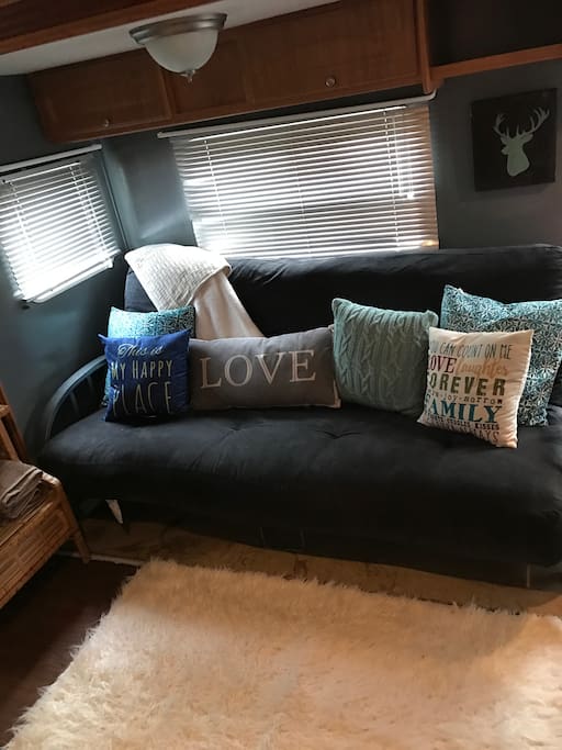 Living area with futon for extra sleepers.