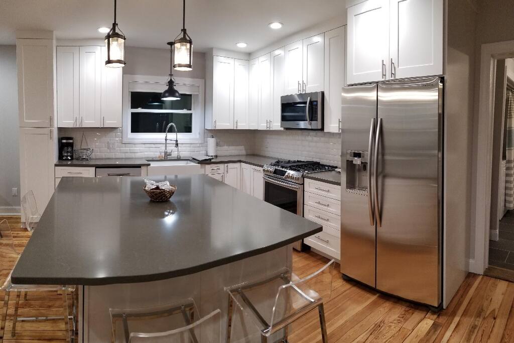 New kitchen with quartz counter tops and top-of-the-line Samsung appliances.