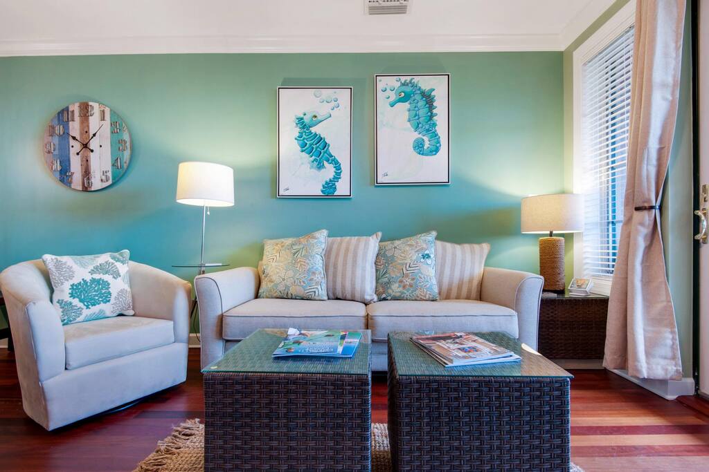 The living area includes two stylish yet comfortable lounge chairs and a sofa for you to watch the sunset!