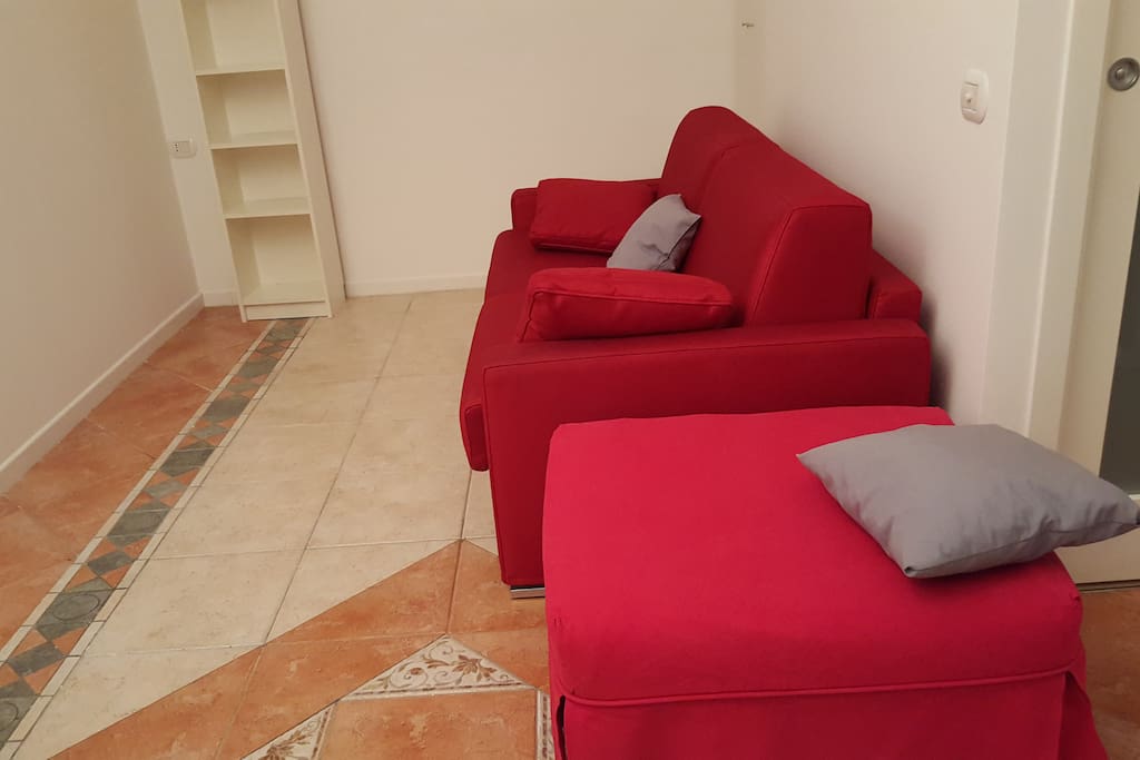 Living area with sofa bed sleeping 2 and another foldable bed