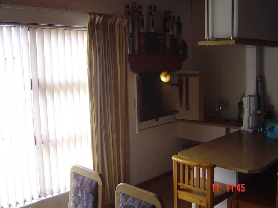 8 Seater dining room table next to inside barbecue