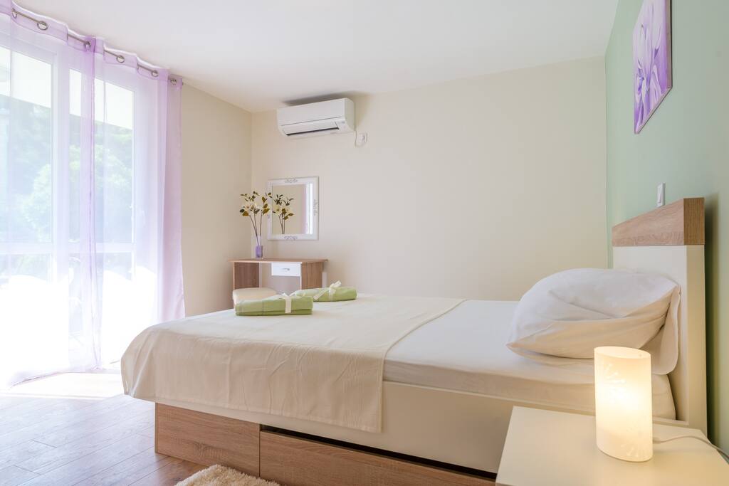 The bedroom has direct access to the balcony
