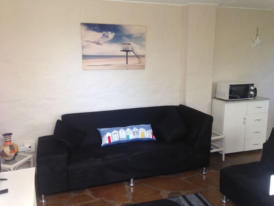 Open plan lounge with DSTV and fully kitted out Kitchen